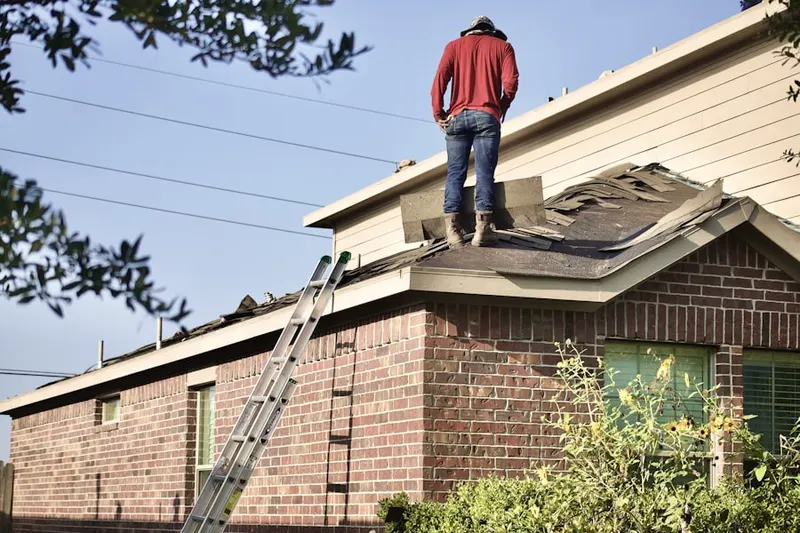 Professional roofer working on a residential roof in Brambleton